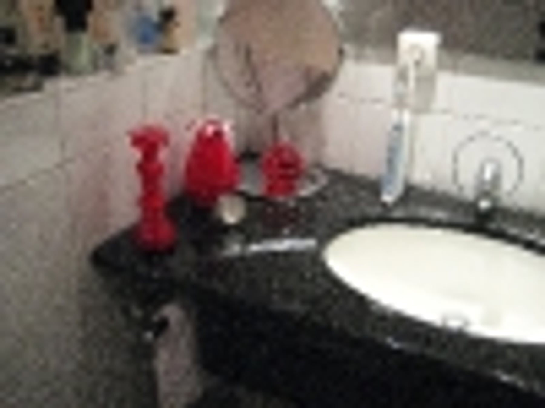 Badezimmer Waschtisch mit Granitplatte und roter Dekoration